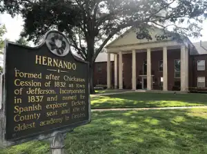 Hernando, MS historic courthouse and landmark sign, showcasing the city's rich history and well-manicured green spaces. Professional lawn care services available in Hernando and the surrounding Mid-South areas.